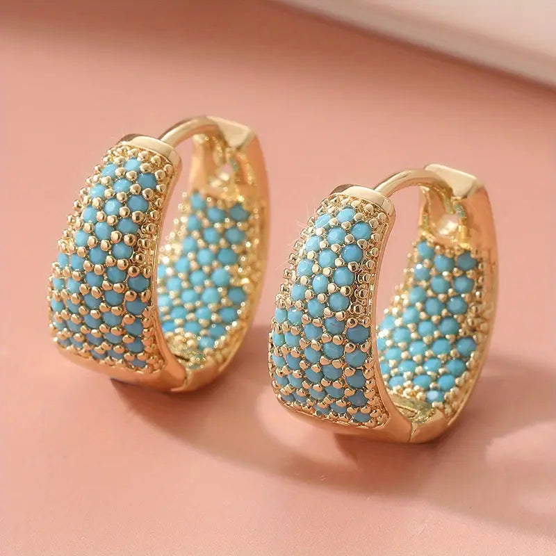 Goudkleurige oorringen met turquoise kralen