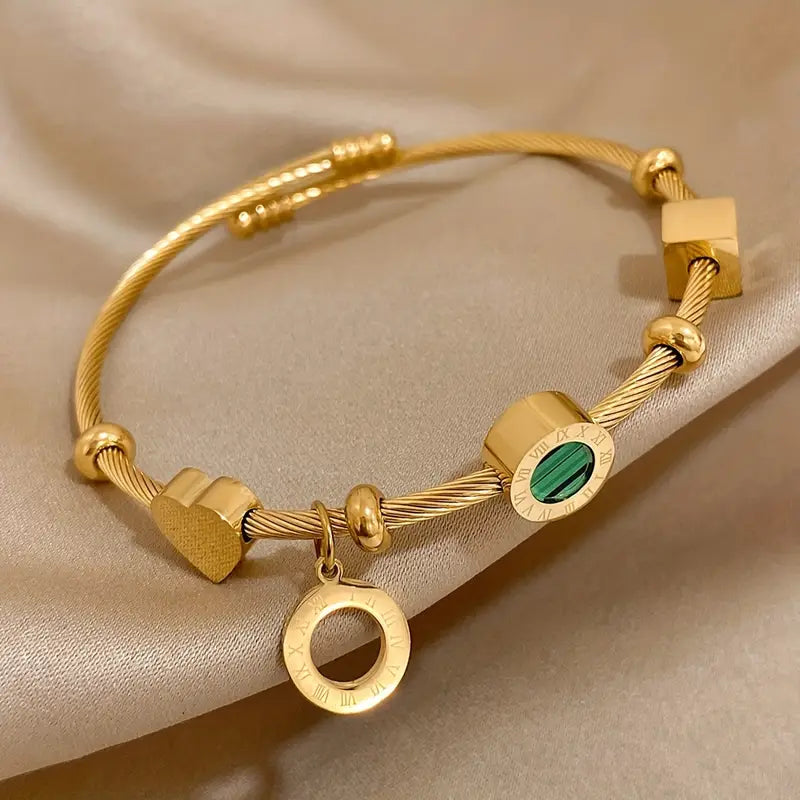 Goudkleurige bedelbangle met groene steenbedel