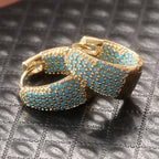 Goudkleurige oorringen met turquoise kralen