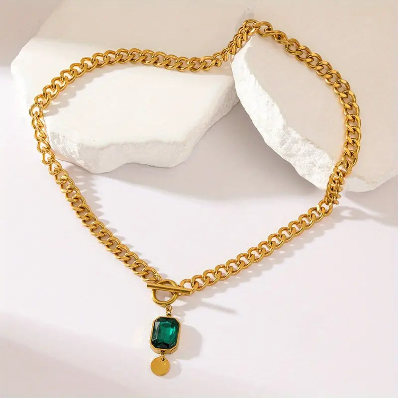 Grove schakelketting met smaragdlook-hanger in goudkleur