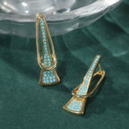 Goudkleurige paperclip-oorhangers met synthetisch turkoois