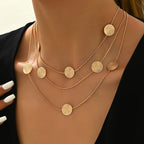 Geometrische gelaagde ketting met spiraaltextuur en meerdere schijfjes