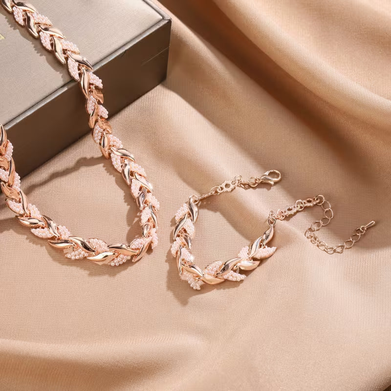 Roségoudkleurige set ketting en armband met bladschakels
