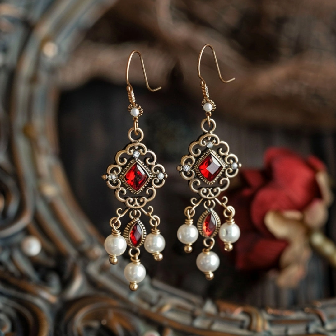 Oorbellen met rood kristal en parel