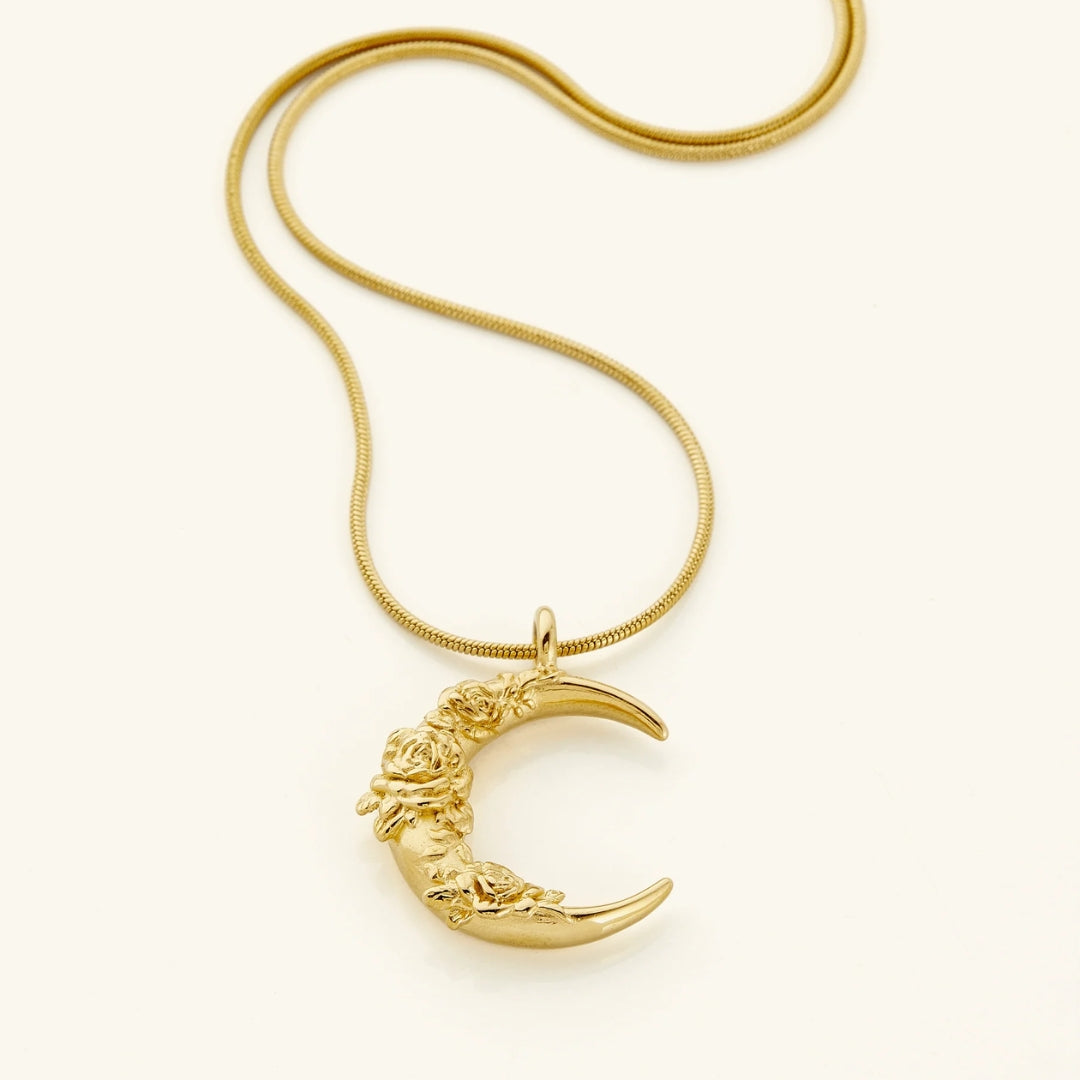 Goudkleurige ketting met hanger met bloem en maan