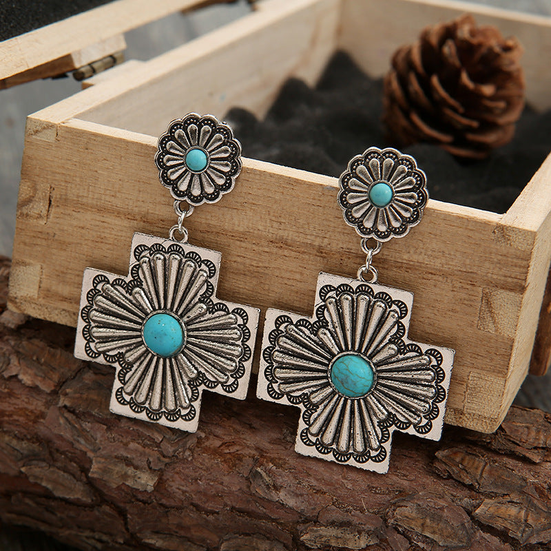 Retro gesneden bloemenoorbellen met turquoise kruis
