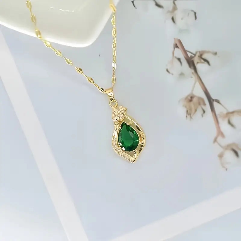 Ketting met bladhanger met groene steen in goudkleur
