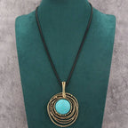 Lange ketting van zwart waskoord met turquoise steen