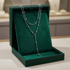 Dubbellaagse lange kralenketting met kwast