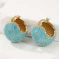 Retro goudkleurige oorringen met turquoise koepel