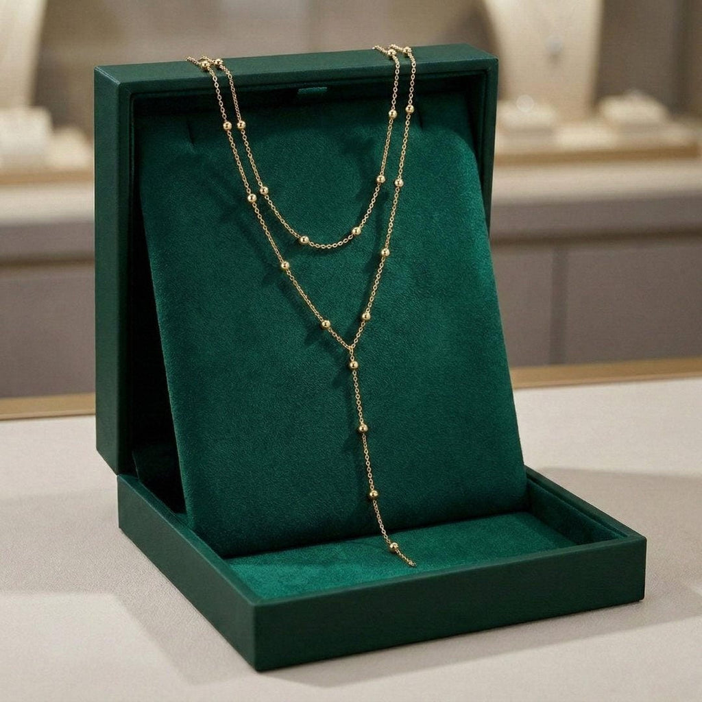 Dubbellaagse lange kralenketting met kwast