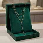 Dubbellaagse lange kralenketting met kwast