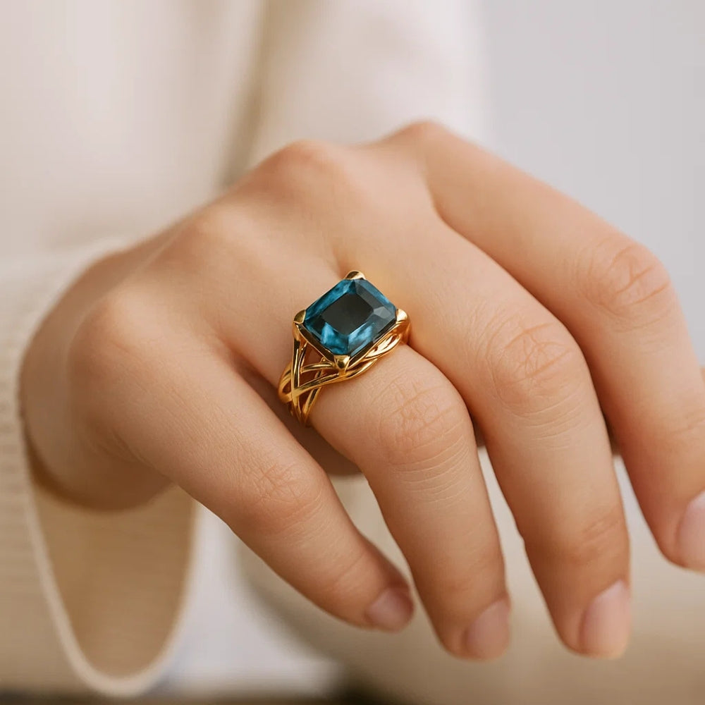 Oval Blue Zirconia Ring with Woven Gold-Tone Band