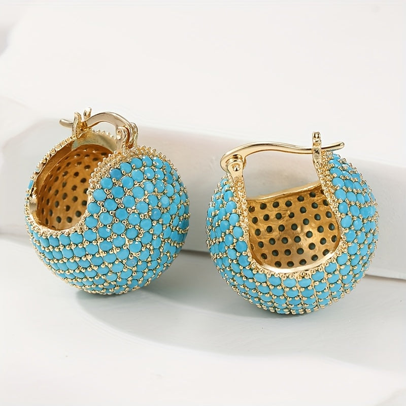 Retro goudkleurige oorringen met turquoise koepel