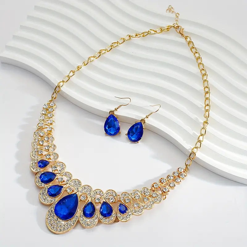 Set van slabketting en oorbellen met blauwe steen in goudkleur