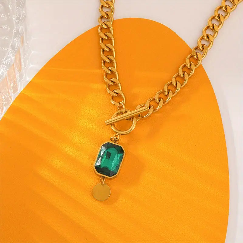 Grove schakelketting met smaragdlook-hanger in goudkleur