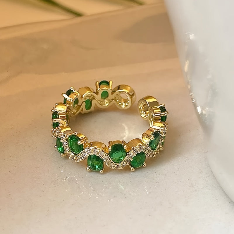 Verstelbare sprankelende open ring met smaragdlook in goudkleur