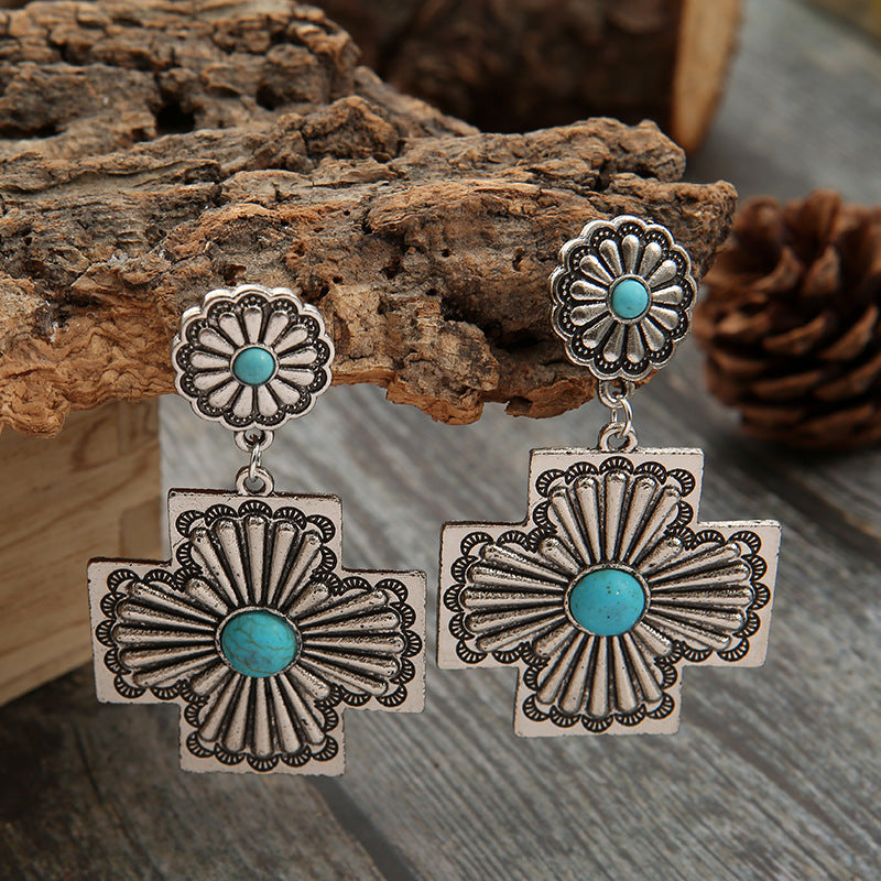 Retro gesneden bloemenoorbellen met turquoise kruis