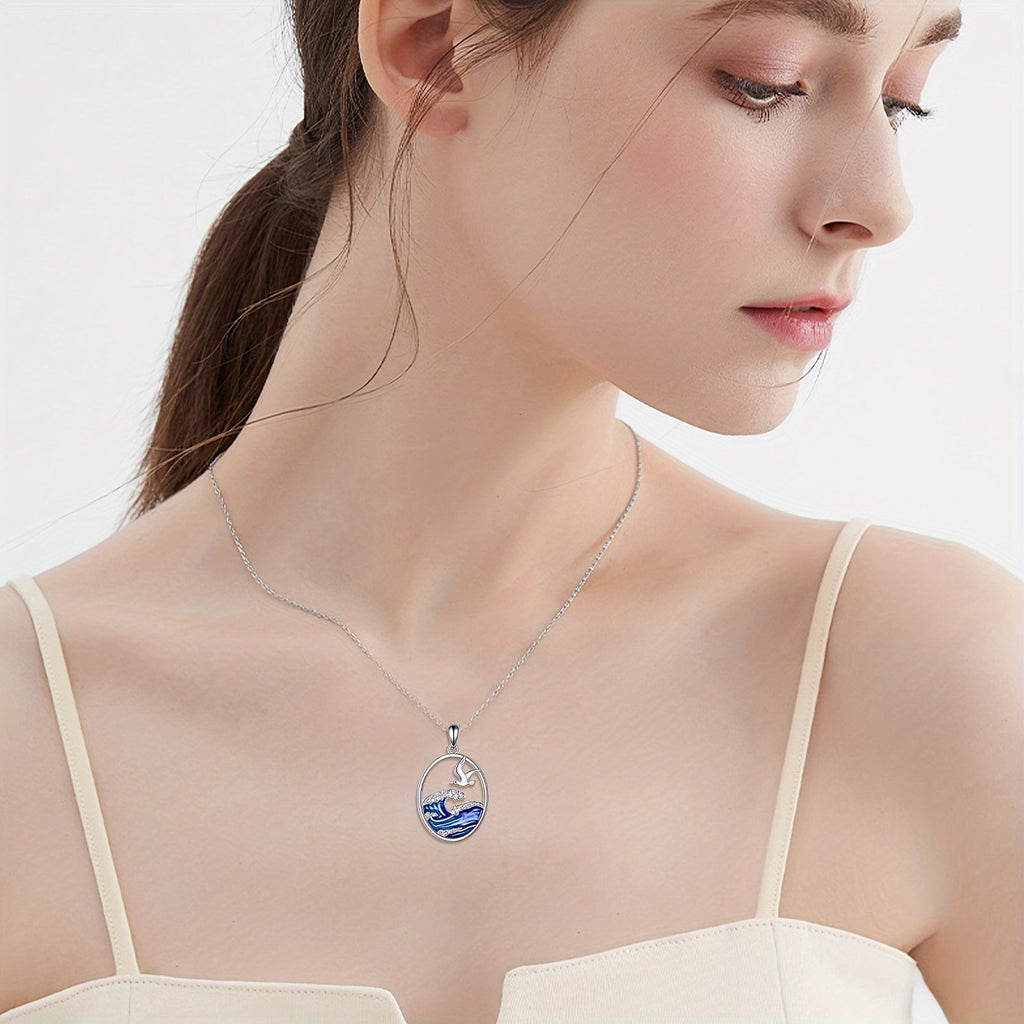 Zilverkleurige ketting met hanger met oceaangolf en meeuw