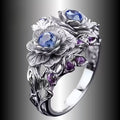 Zilverkleurige ring met twee bloesems