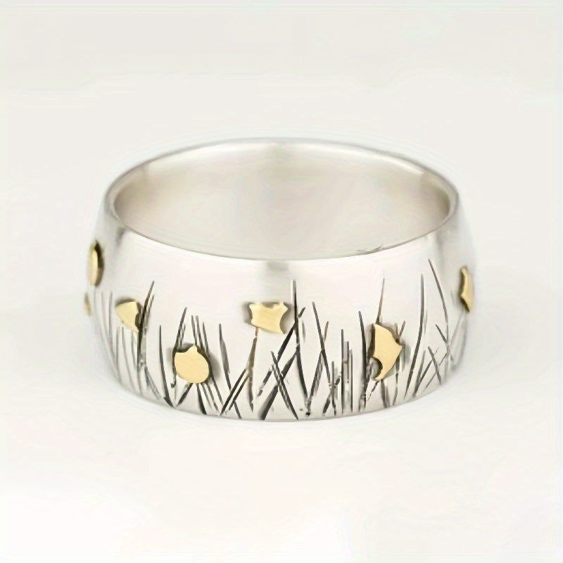 Retro tweekleurige ring in etnische stijl met bloem en gras