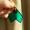 Geometriske øreringe i vintagestil i grønt glas