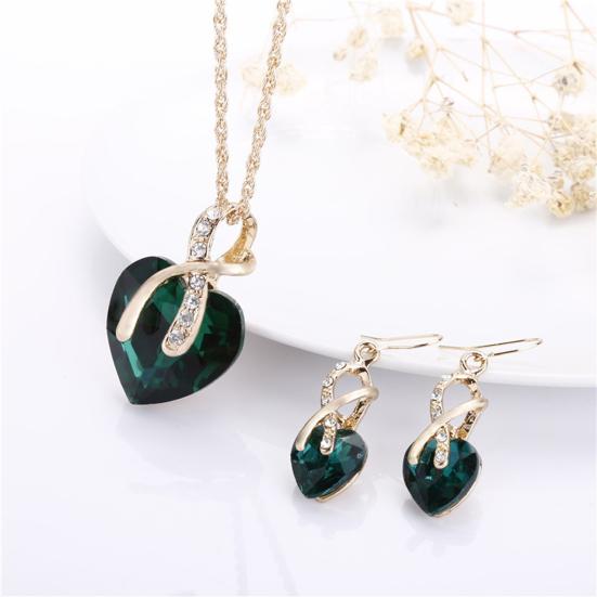 Set met ketting en oorbellen met groen kristallen hart en krul