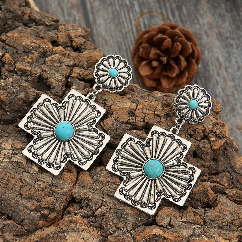 Retro gesneden bloemenoorbellen met turquoise kruis