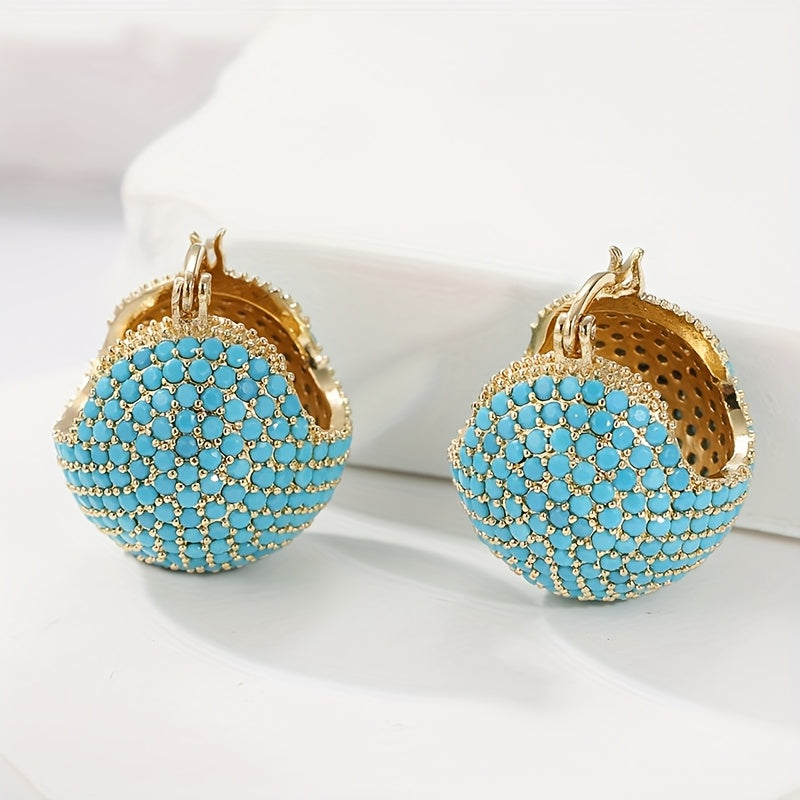 Retro goudkleurige oorringen met turquoise koepel