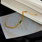 Gold-Tone Double Chain Bracelet with Green Baguette Stone