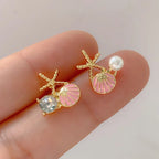 Zeesteroorbellen met schelp- of pareldetail