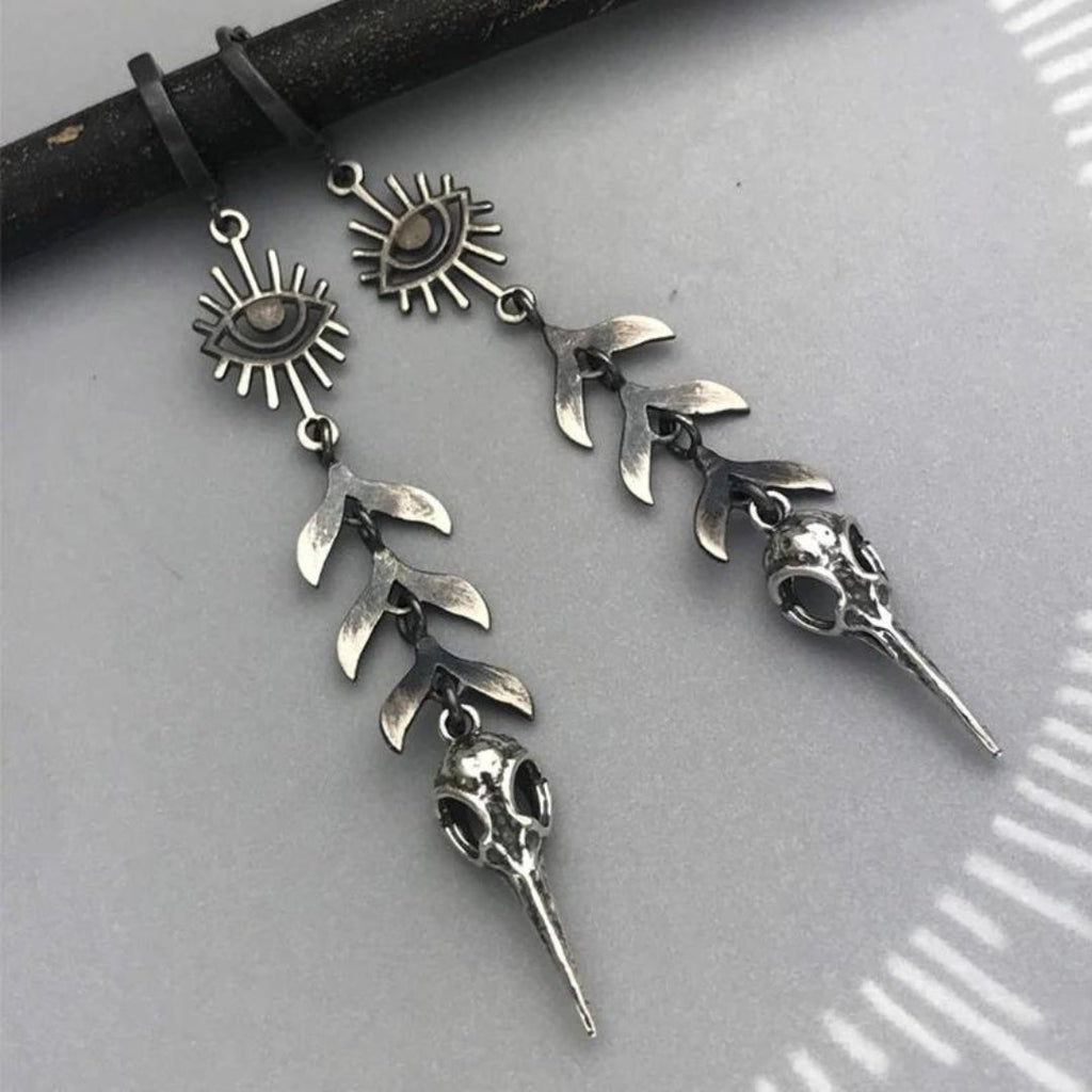 Boho oorbellen met maskerhanger in zilverkleur