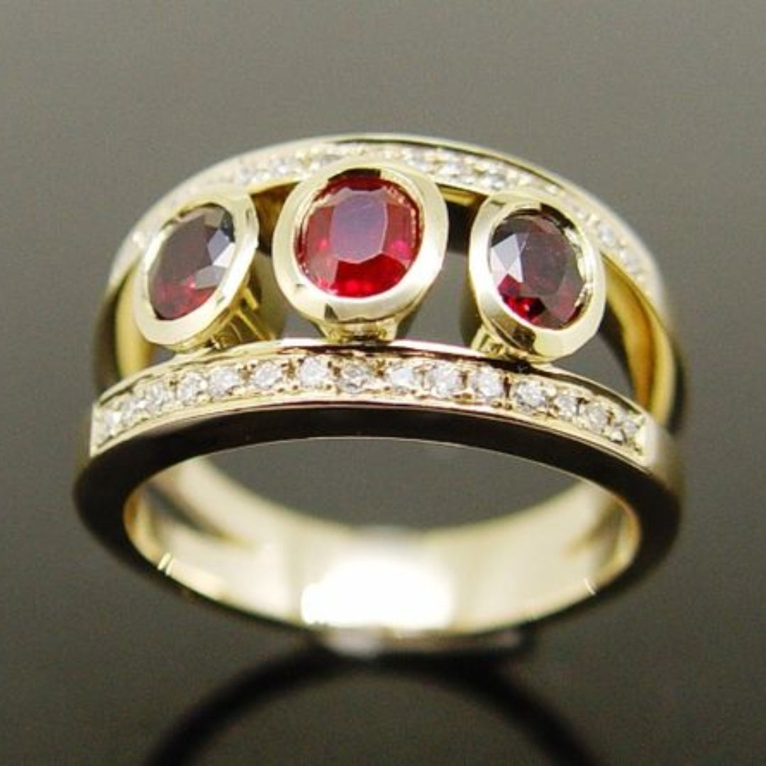 Goudkleurige bandring met drie rode zirkonia
