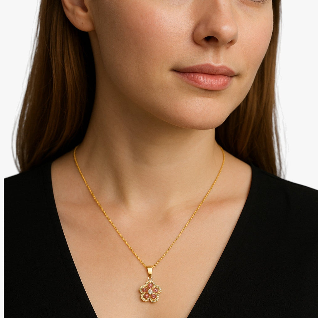 Goudkleurige ketting met ring en draaiende zirkonia bloem