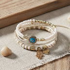 Armbandenbundel met hamsahand en parelaccenten