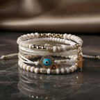 Armbandenbundel met hamsahand en parelaccenten