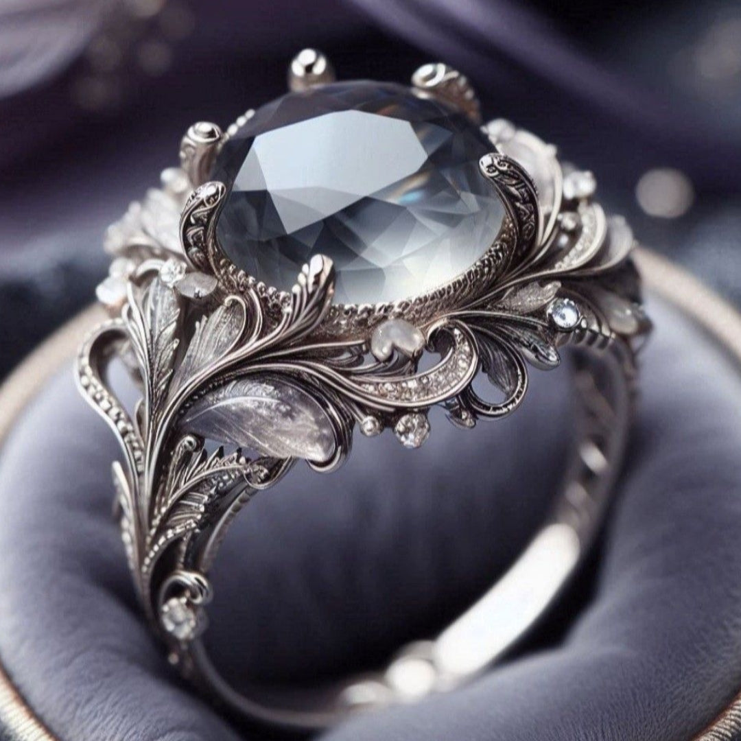 Zilverkleurige ring met grijze steen en exotisch ontwerp