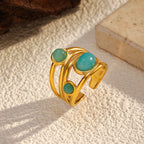 Goudkleurige draadring met twee turquoise stenen, statement