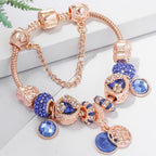 Roze zilverkleurige armband met blauw kristal