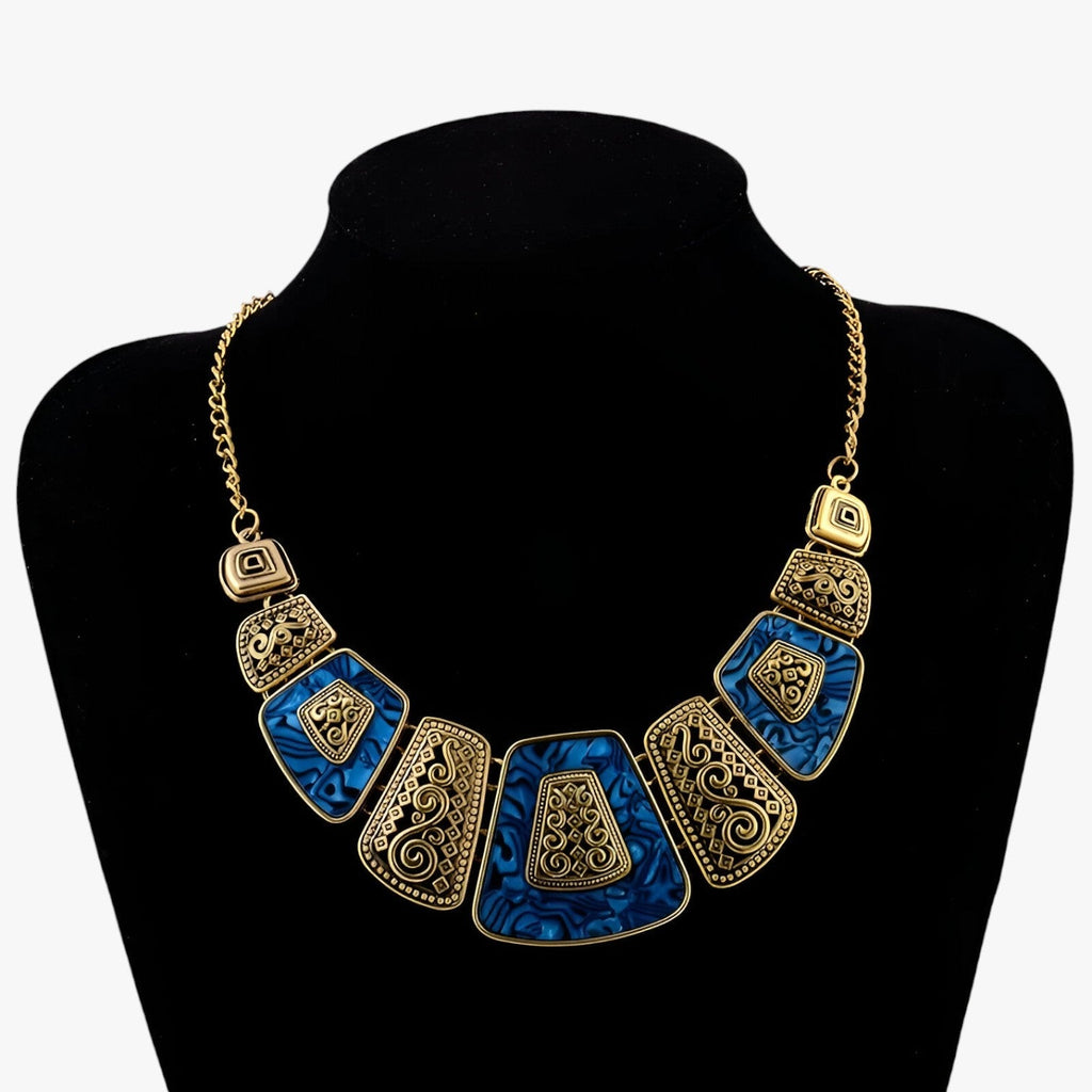 Goudkleurige statement choker met blauw detail