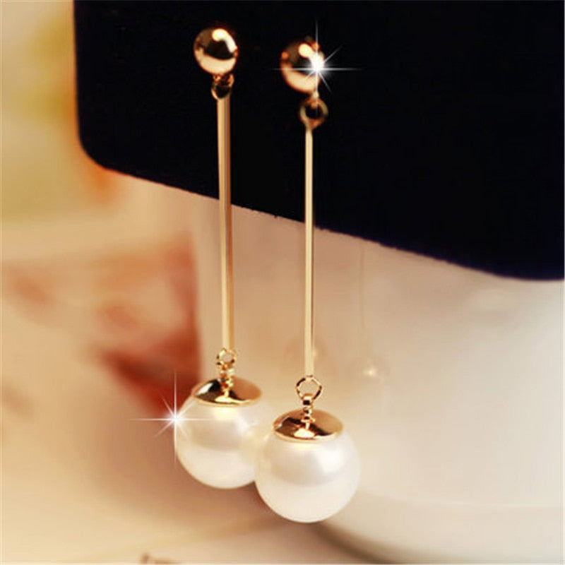 Oorhangers met parelstaafje aan lange ketting
