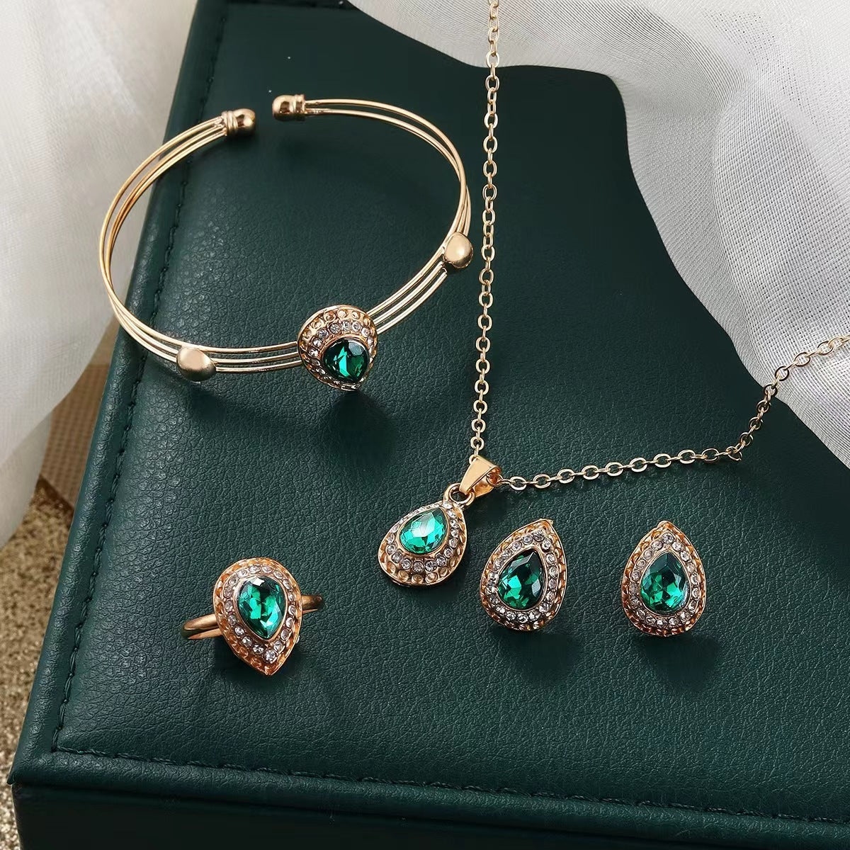 Set met ketting, oorbellen, armband en ring met groene druppel