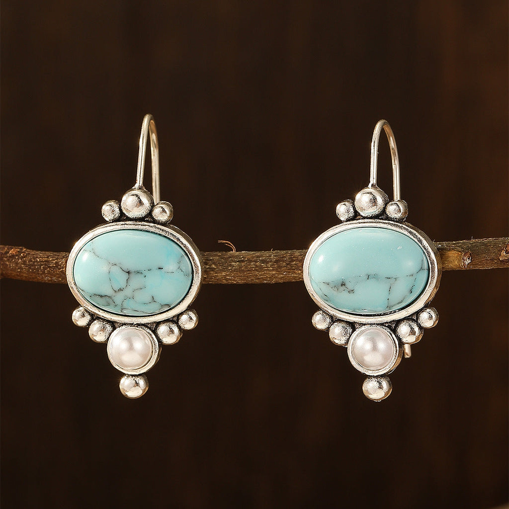 Oorhangers met ovale turquoise steen en pareldetail