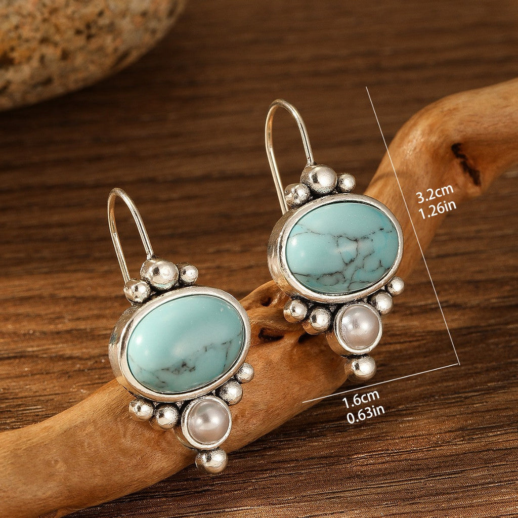 Oorhangers met ovale turquoise steen en pareldetail