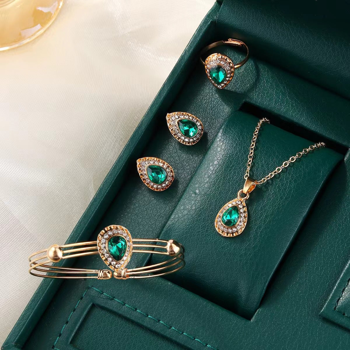 Set met ketting, oorbellen, armband en ring met groene druppel