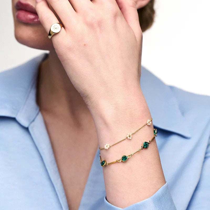 Schakelarmband met smaragdlook in goudkleur