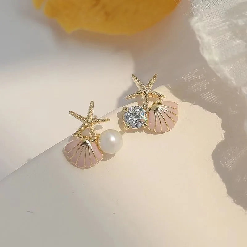 Zeesteroorbellen met schelp- of pareldetail