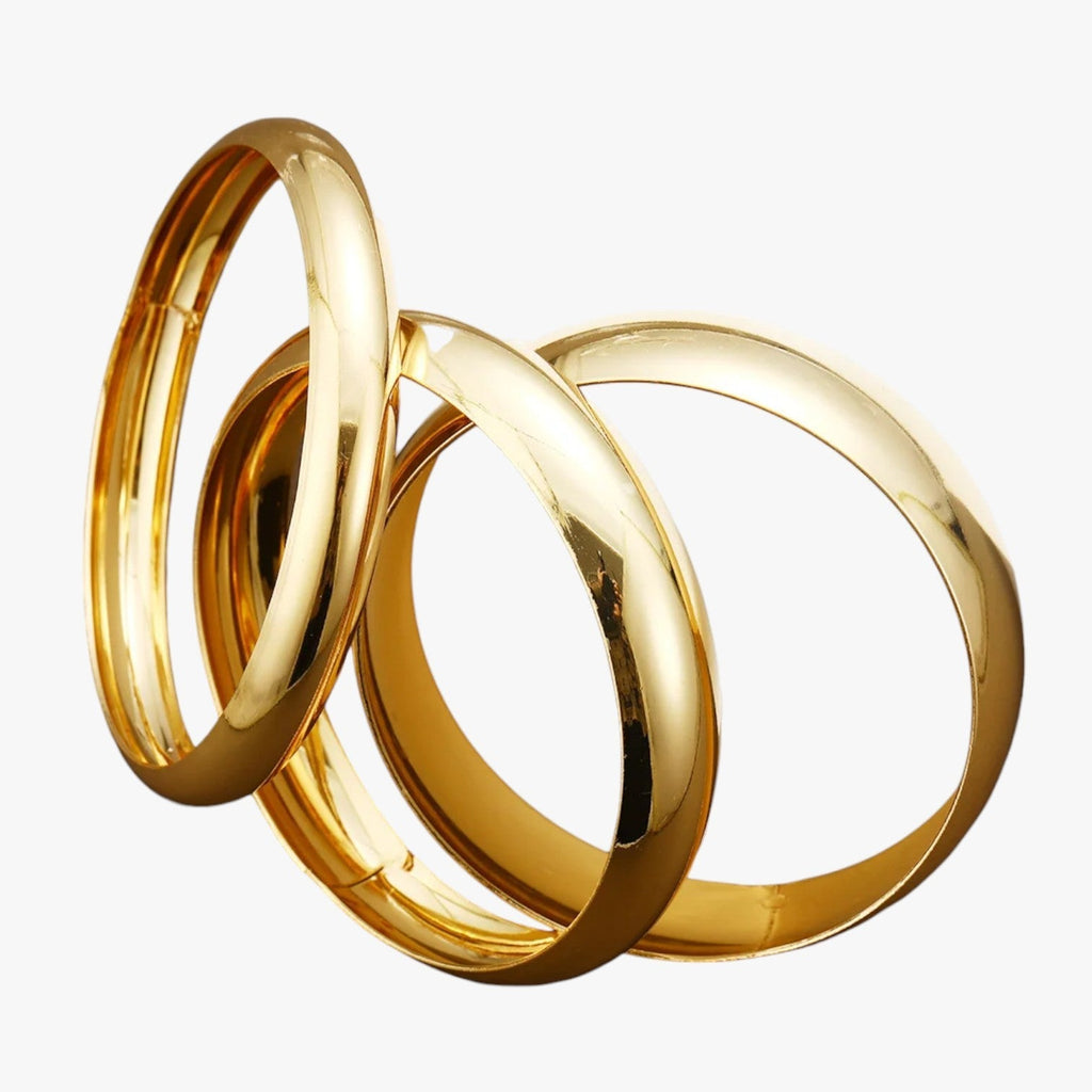 Set van drie brede bangles, goudkleurige afwerking