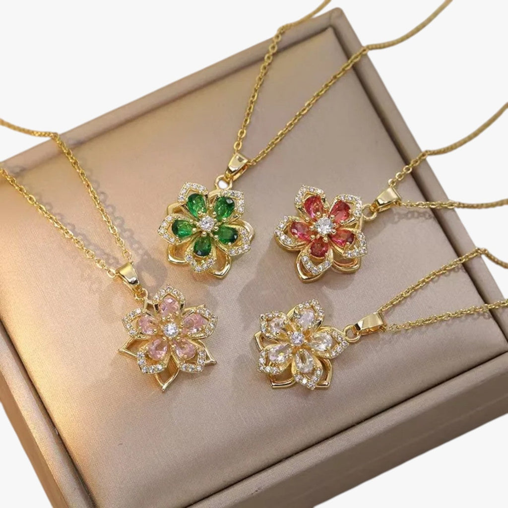 Goudkleurige ketting met ring en draaiende zirkonia bloem