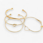 Set ineengevlochten stalen armbanden, goudkleurig